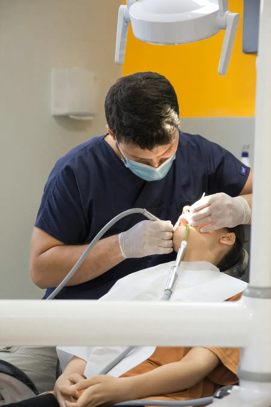 Hygienist cleaning a patient's teeth