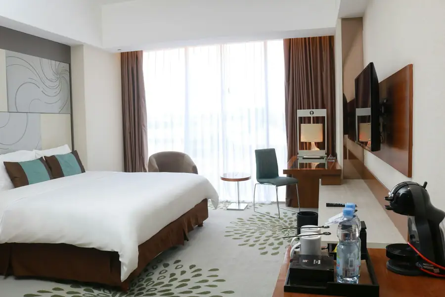 Bright room with two beds and a desk