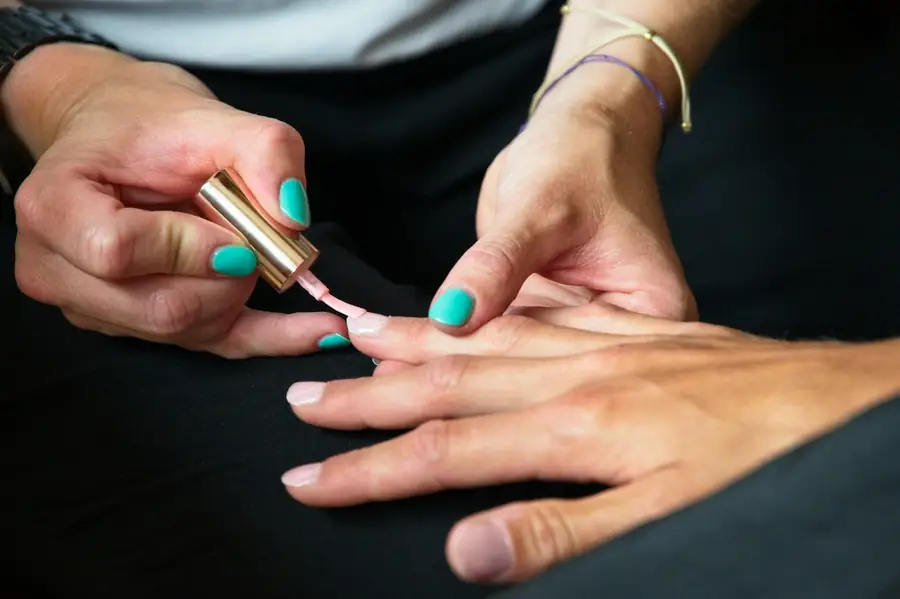 Nail technician applying polish