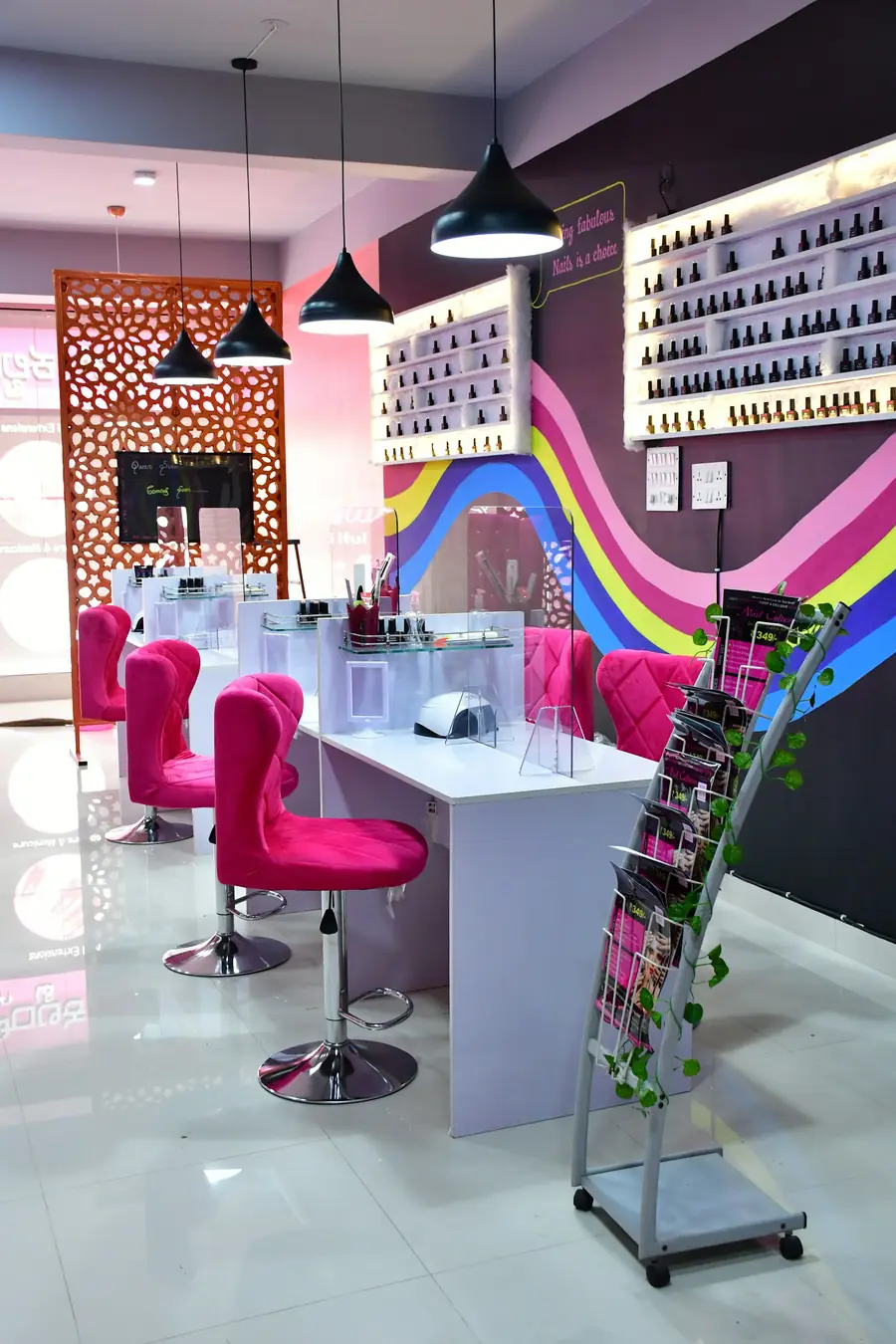 Bright pink and white nail salon with manicure stations